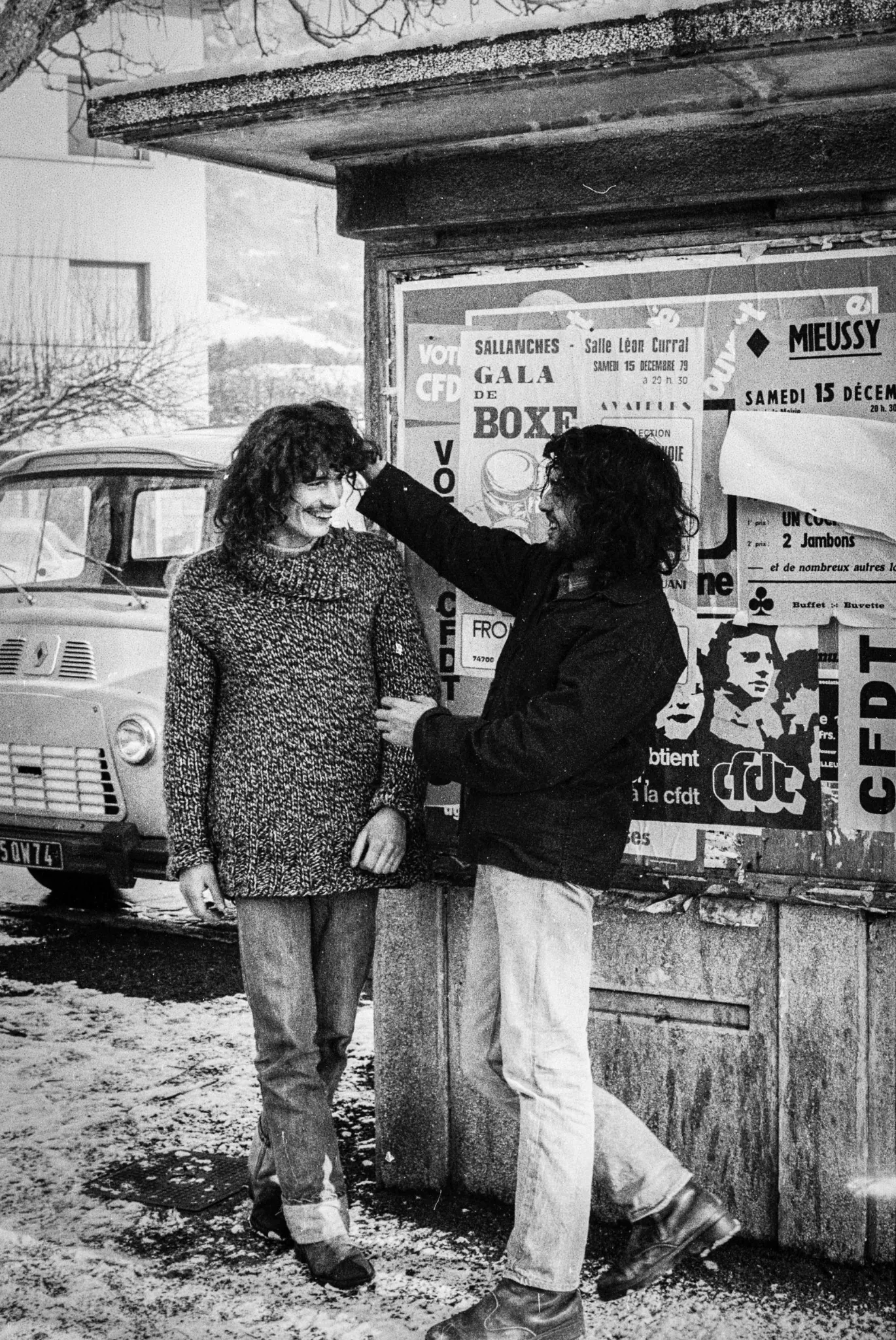 Photographie de Gaby Burtin : deux personnes devant un mur d’affiches en 1979